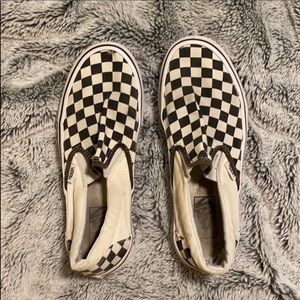 Checkered Vans with a few holes